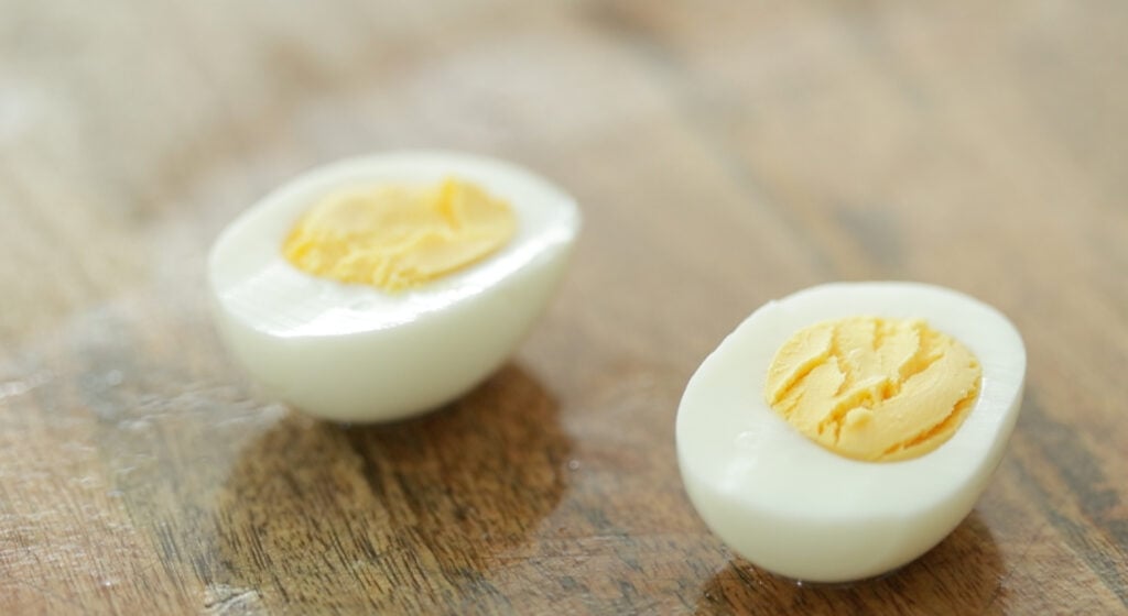 slicing a hard boiled egg in half
