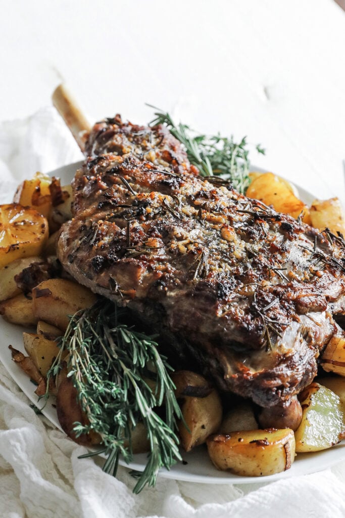 bone in roasted leg of lamb with herbs and potatoes