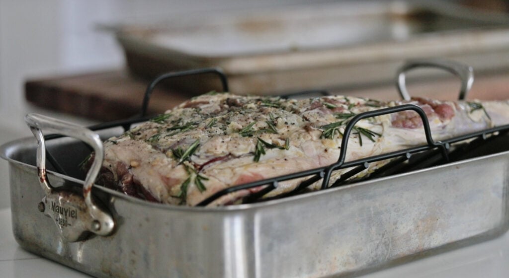 placing lamb leg in a roasting rack