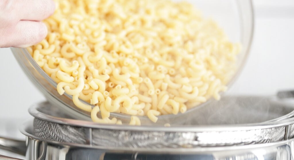 boiling macaroni noodles in a large pot of boiling water