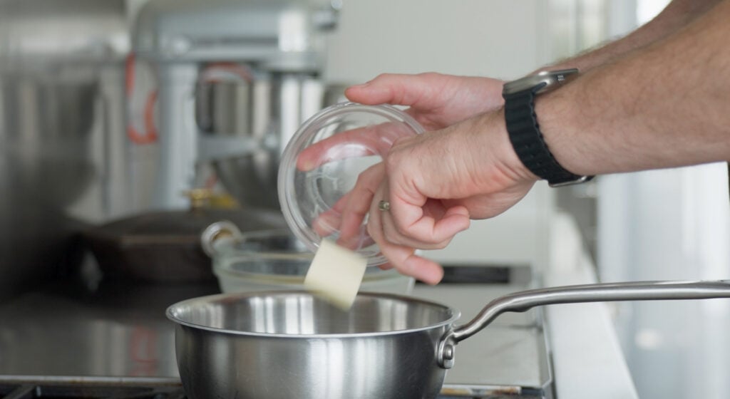 Putting butter into a pan