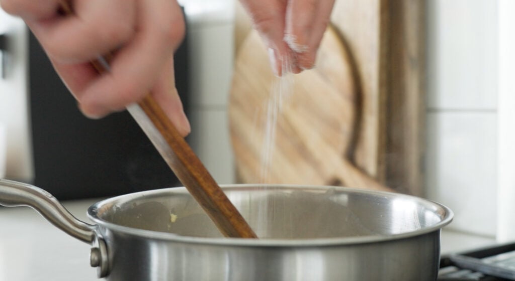sprinkling salt into the pan