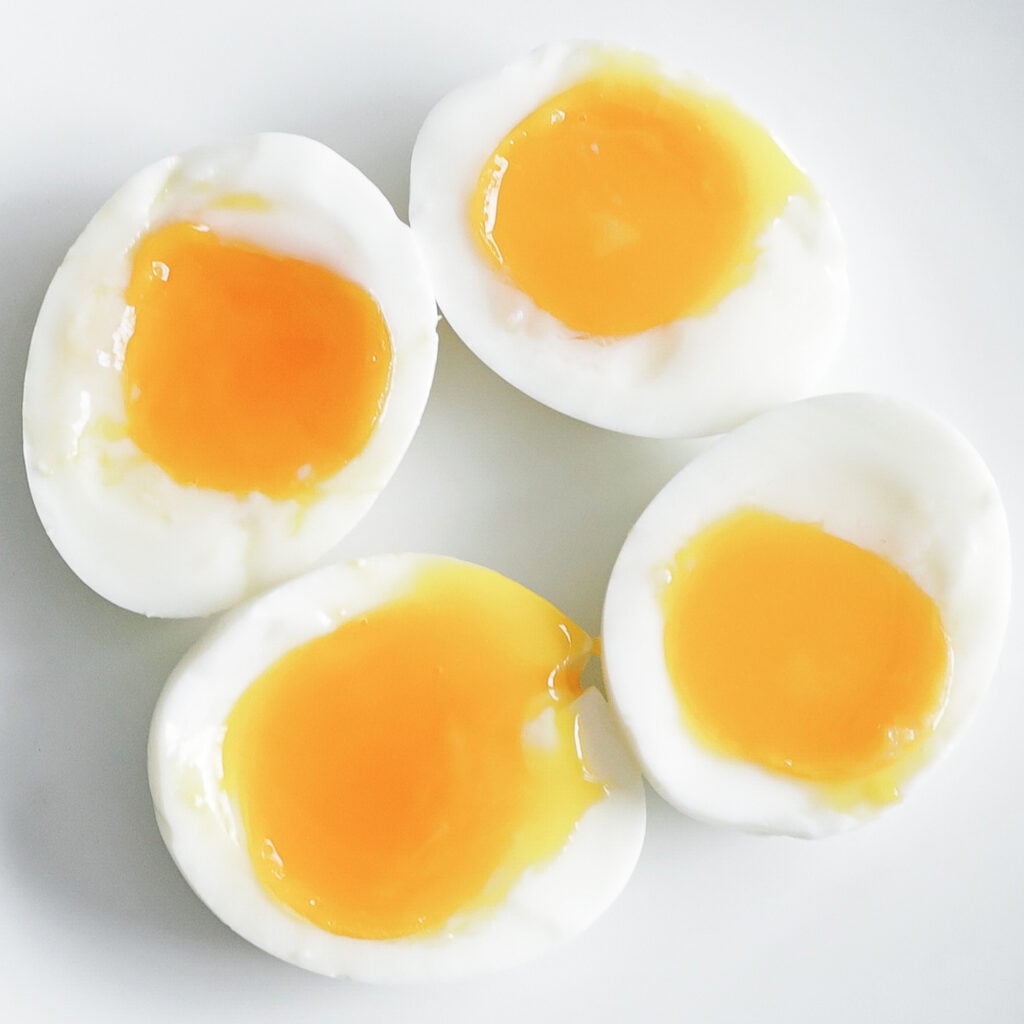 soft boiled eggs sliced in half on a plate