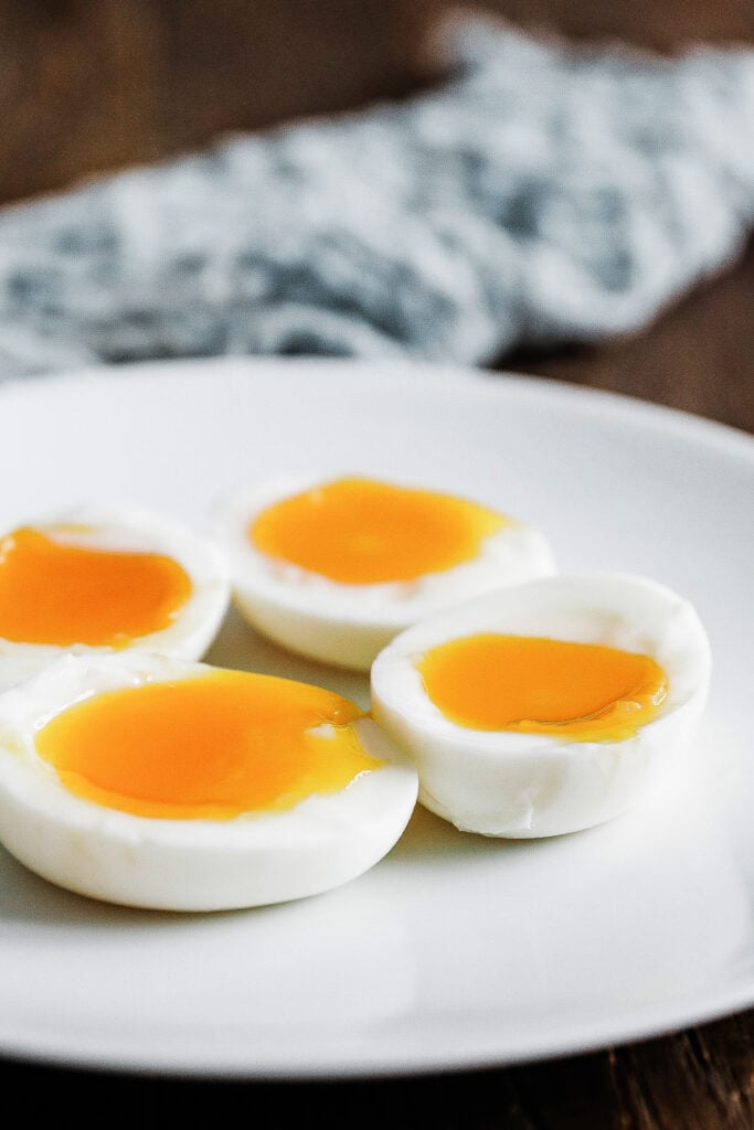 jammy soft boiled eggs on a plate