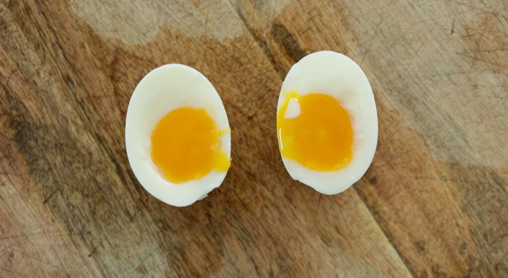 sliced soft boiled egg on a cutting board