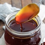 annatto oil being poured into a jar