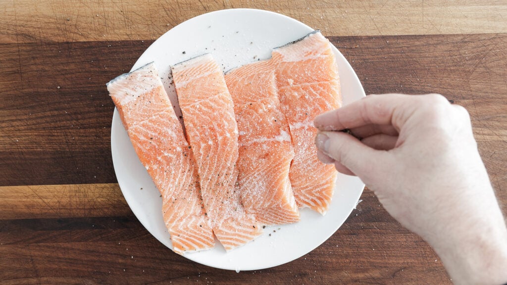 seasoning the salmon fillets