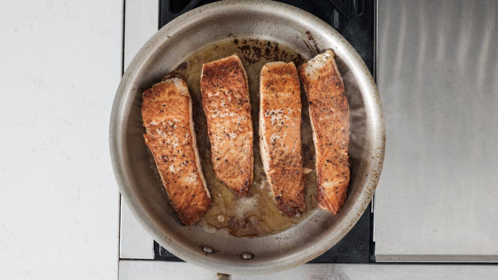 searing the salmon in a pan