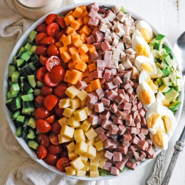 classic chef salad in a bowl with a thousand island dressing on the side