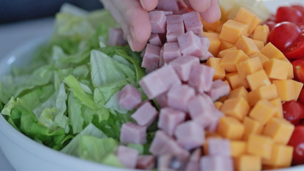 making a chef salad with toppings