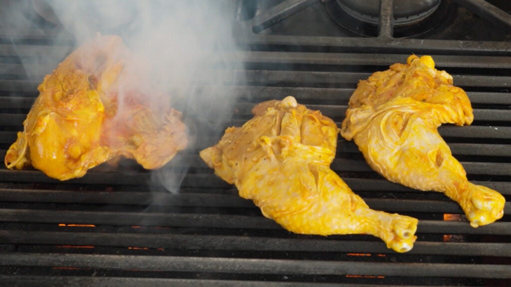 Chicken pieces on a hot grill
