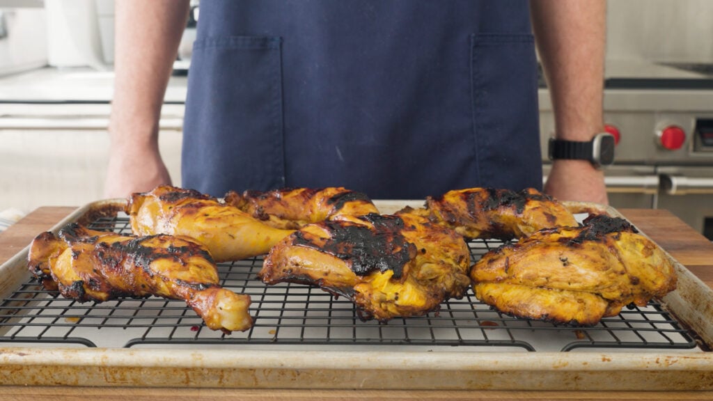 Grilled chicken presented on a wire rack