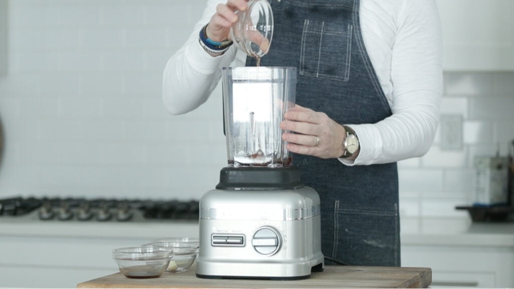 adding oil to a blender