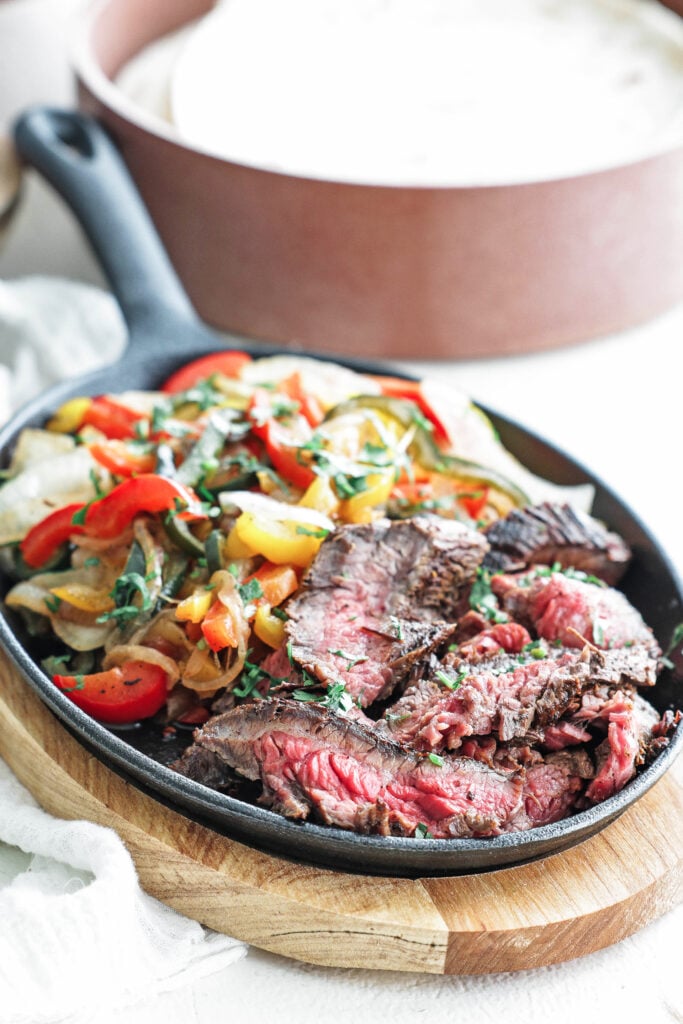 steak fajitas with tortillas, guacamole, and pico de gallo