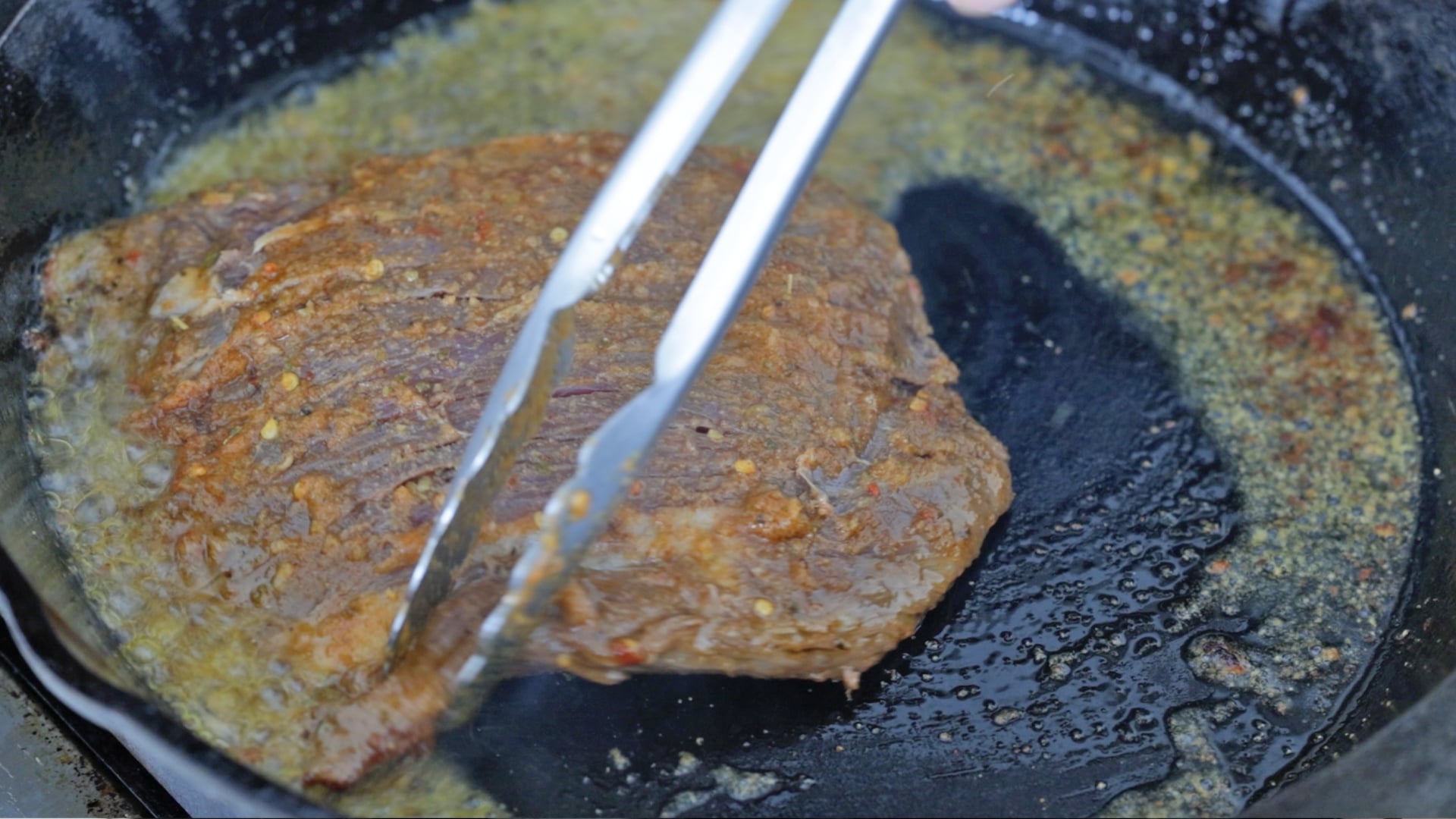 moving a steak around in a pan
