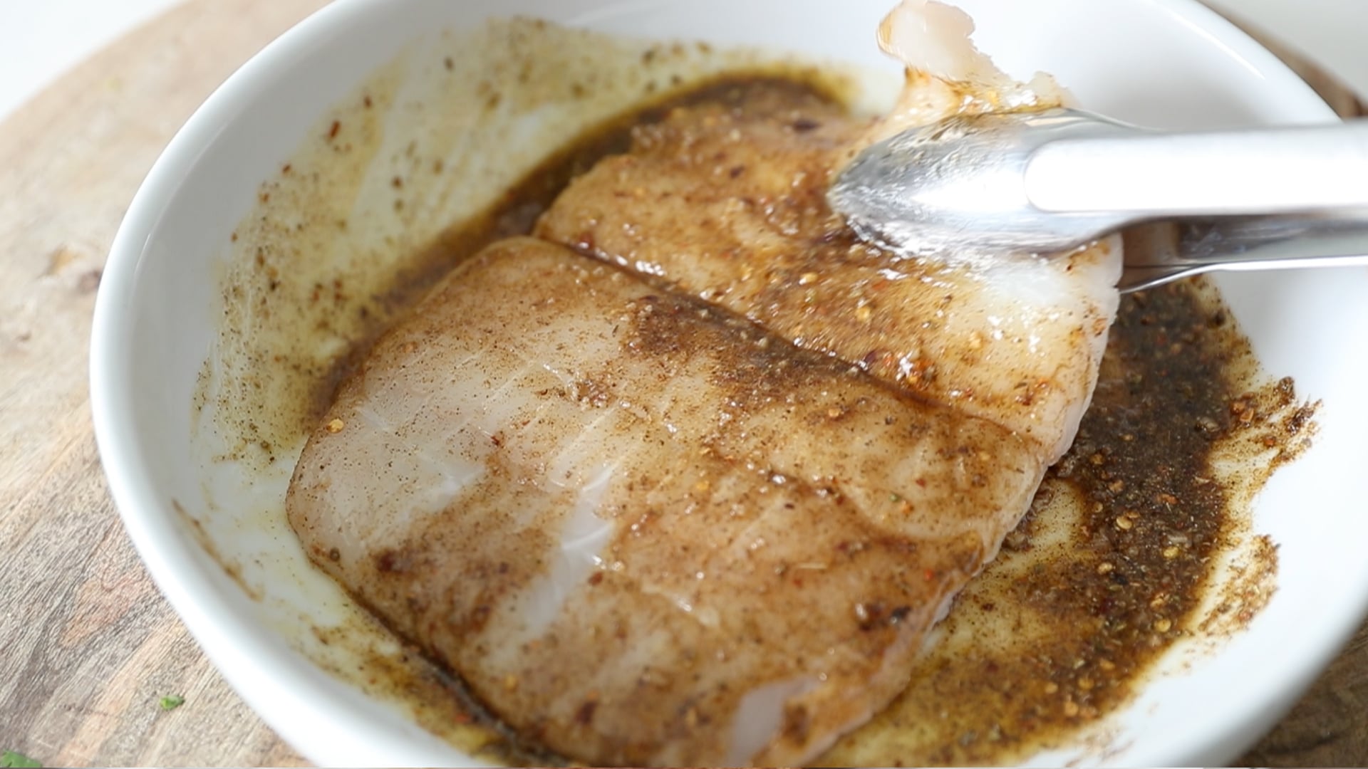 coating fish in a spice rub