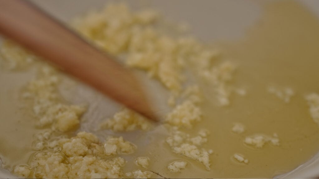 stiring the garlic and oil in the skillet