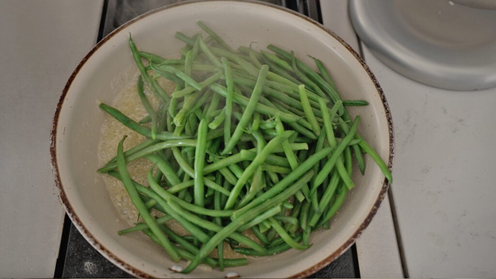 Green beans added to the skillet