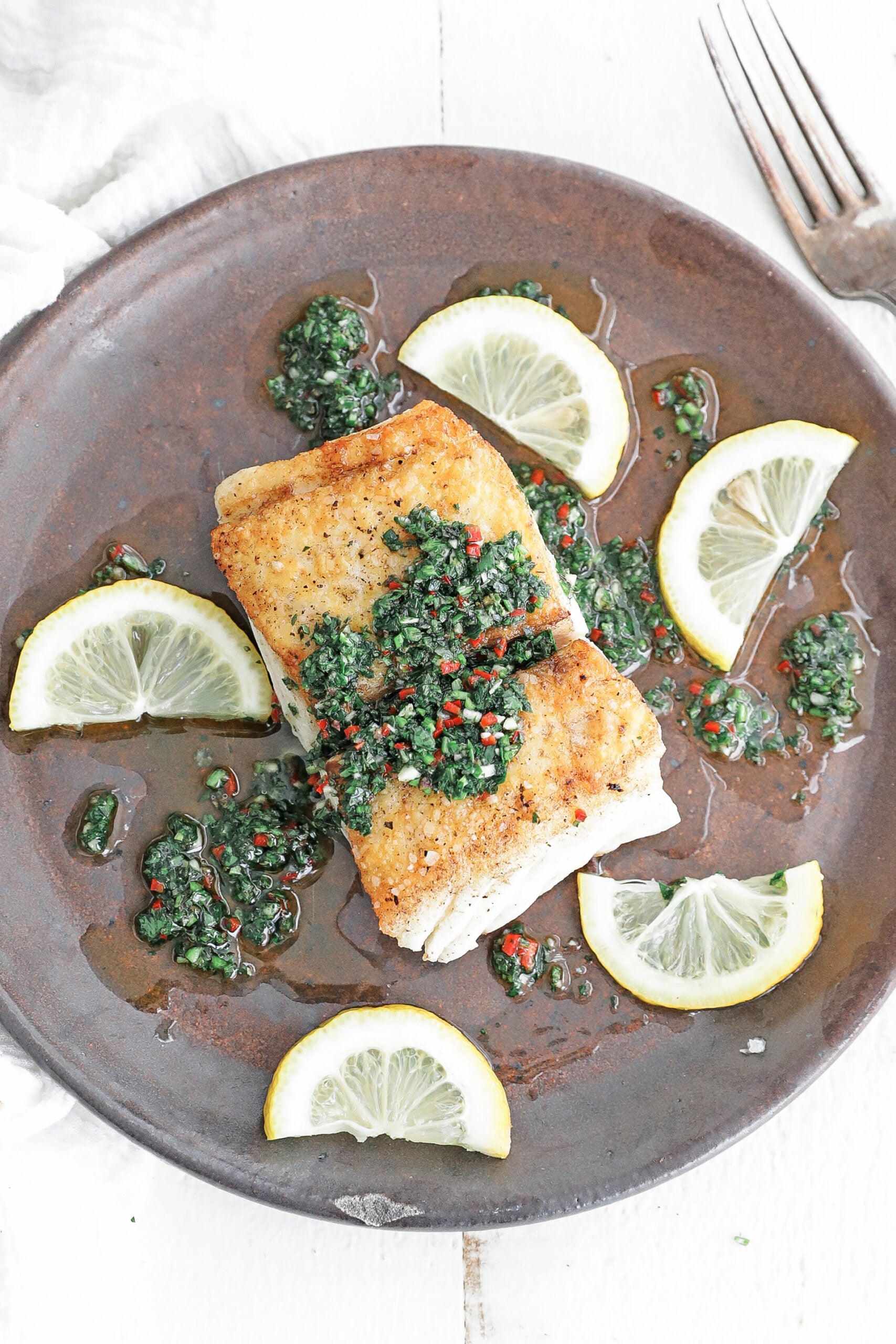 halibut with chimichurri sauce and lemons