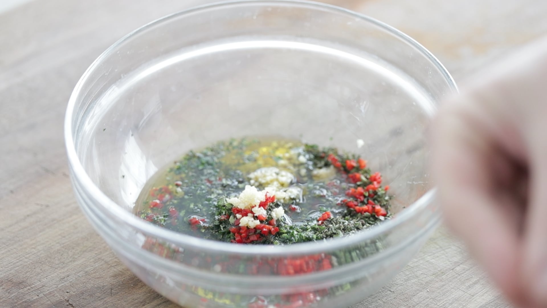 mixing together a chimichurri sauce