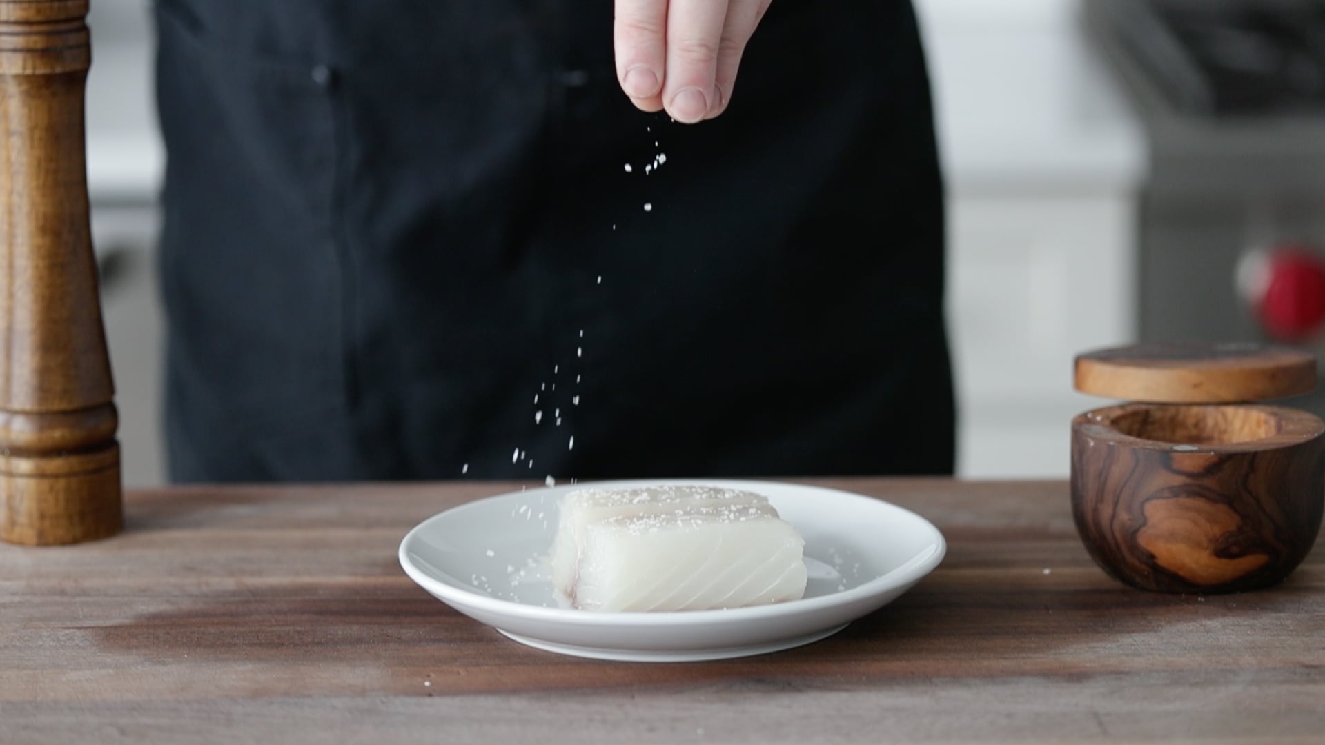 seasoning a fresh halibut fish fillet