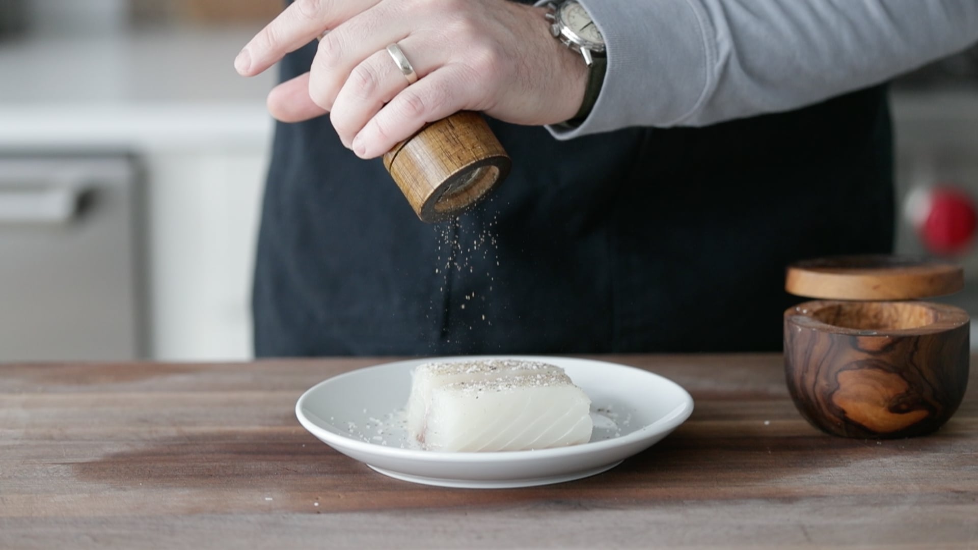 seasoning a fresh halibut fish fillet