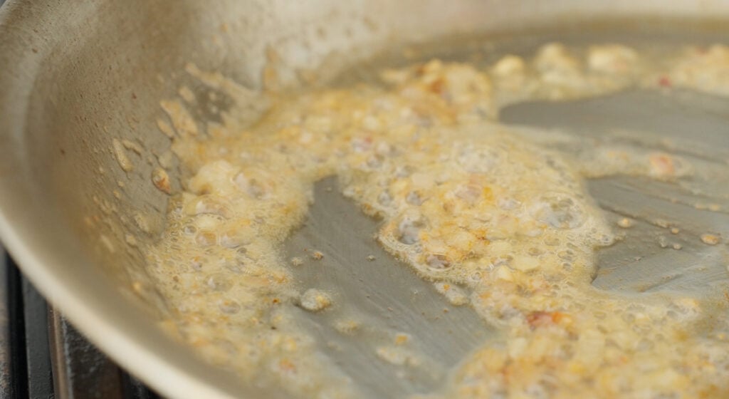 Shallots and garlic browning in the butter in the pan