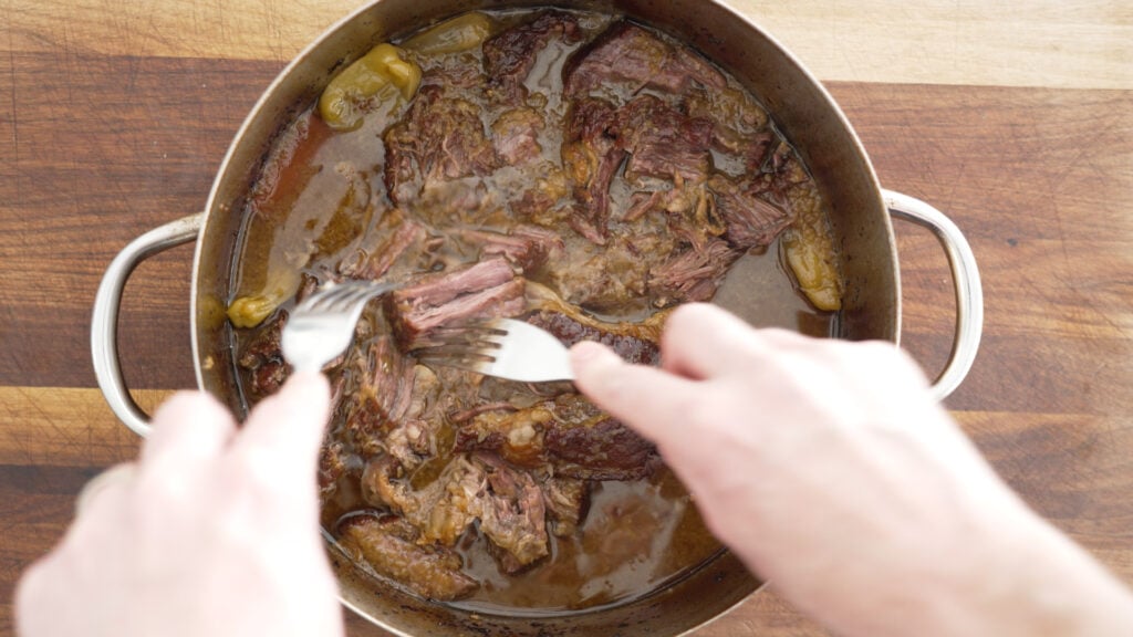 Using two forks to shred the roast