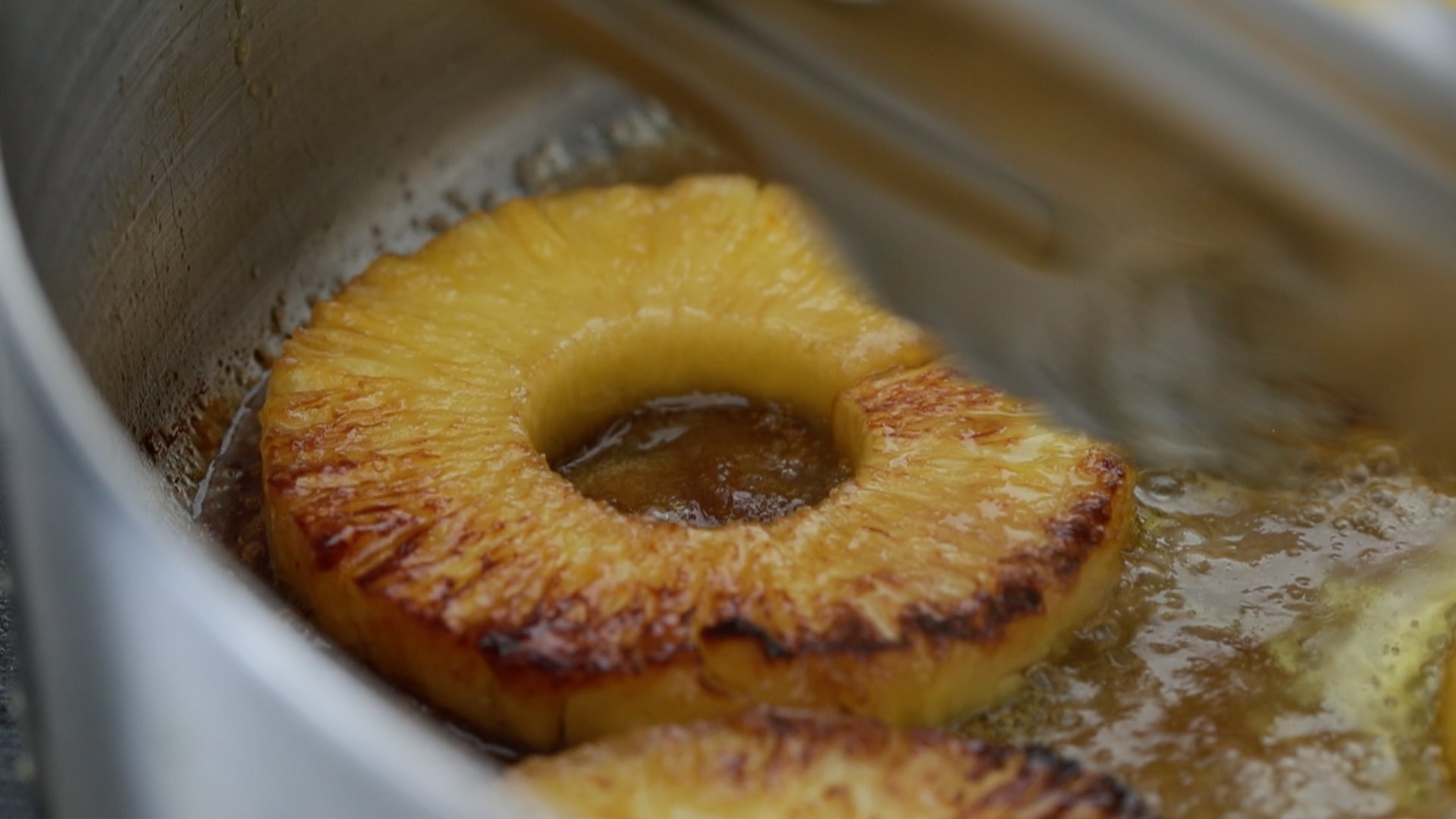 adding pineapple to a pan