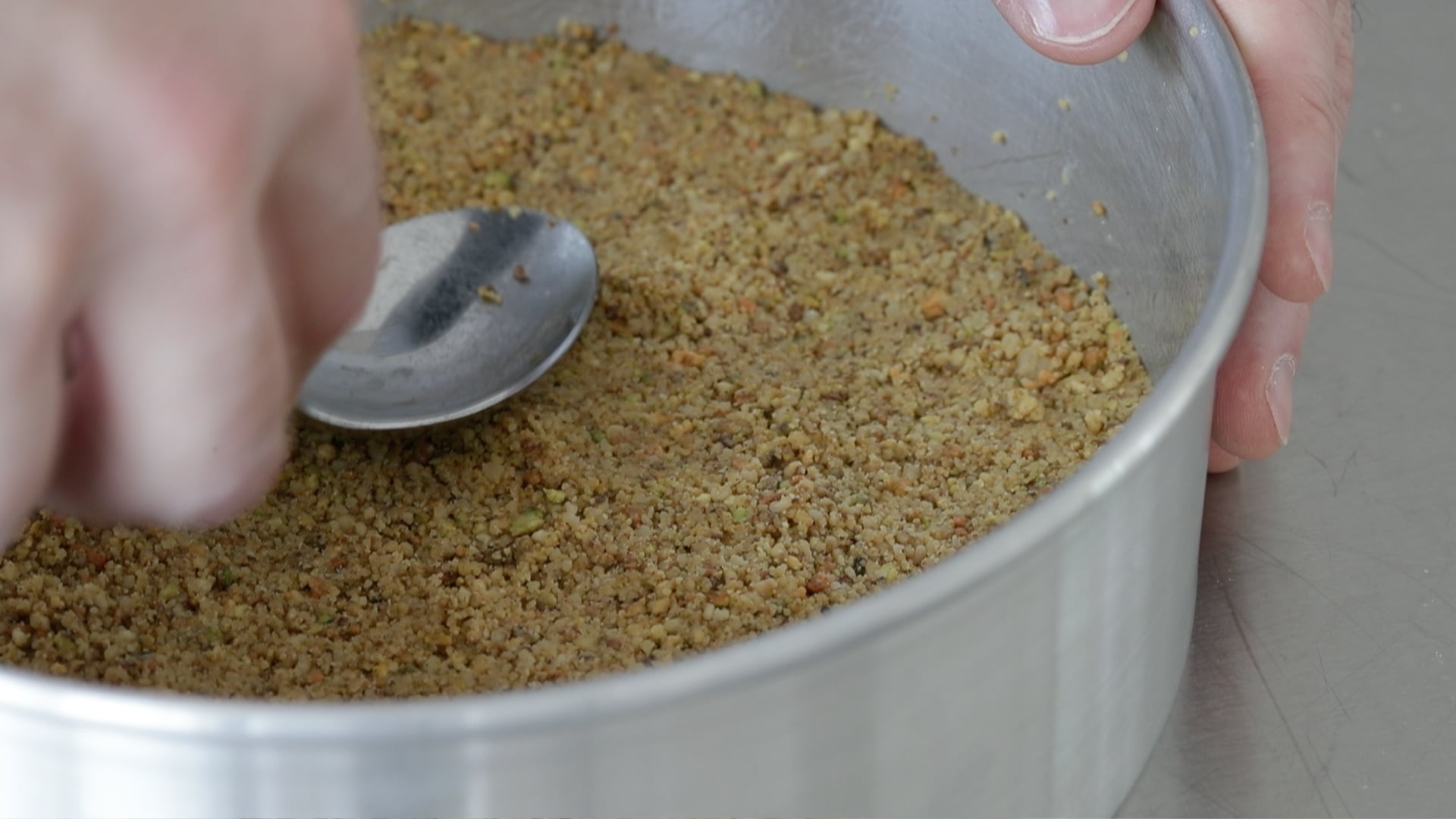 adding nuts to a cake pan