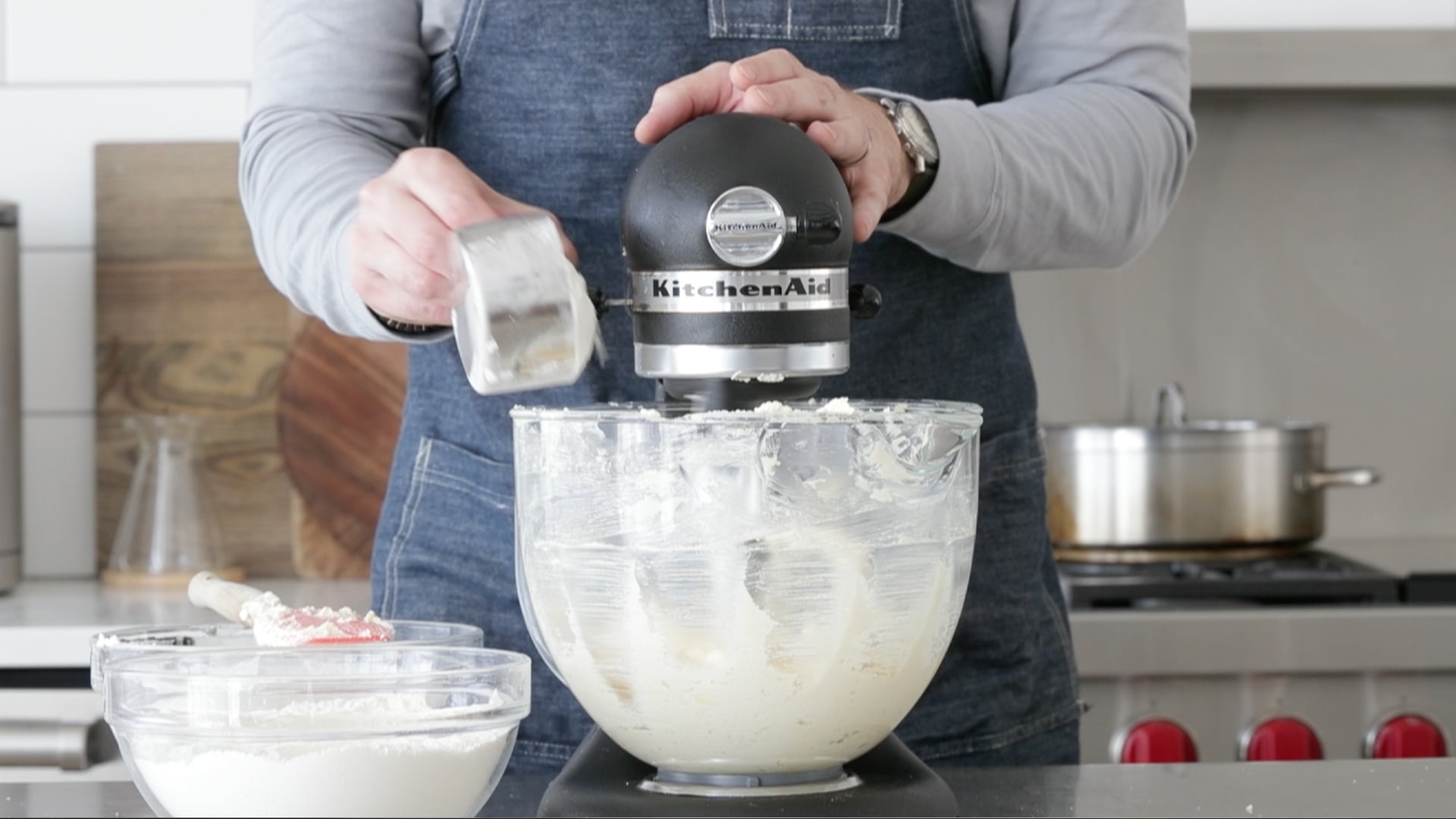 adding flour to a mixer