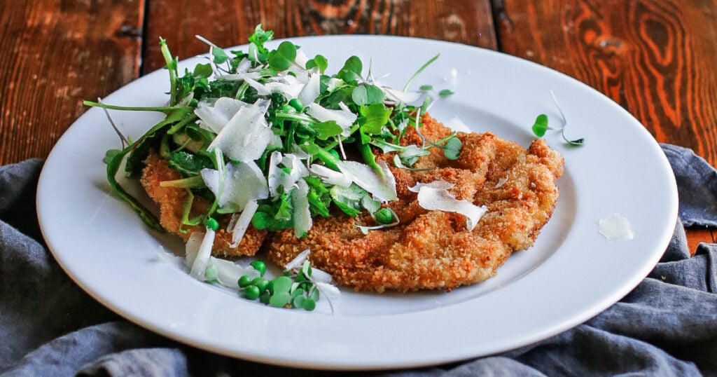 Pork Milanese serving with salad
