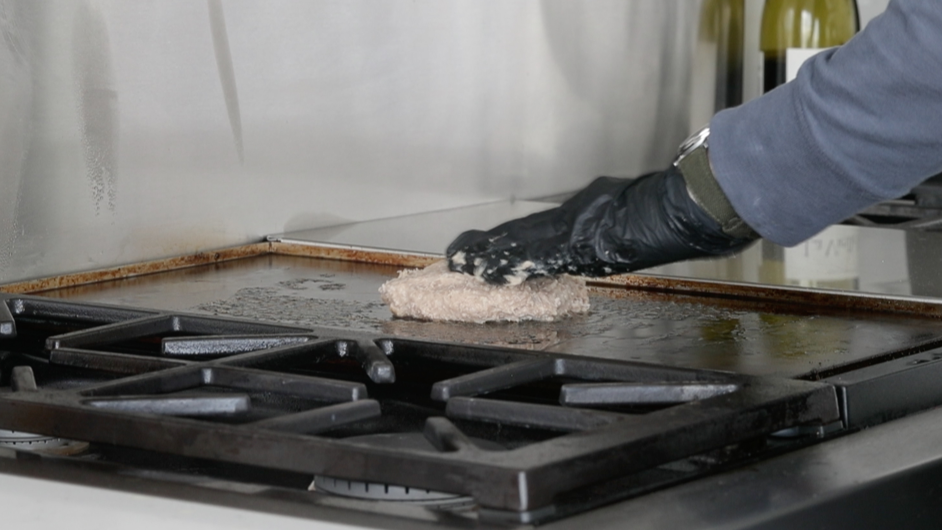 adding a turkey burger to a griddle