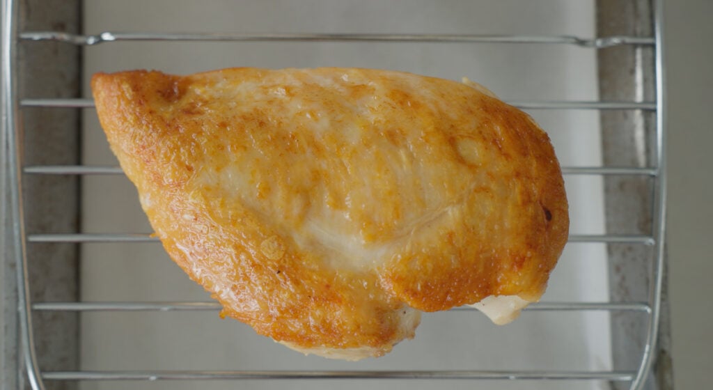 Close up of a browned, pan seared chicken breast