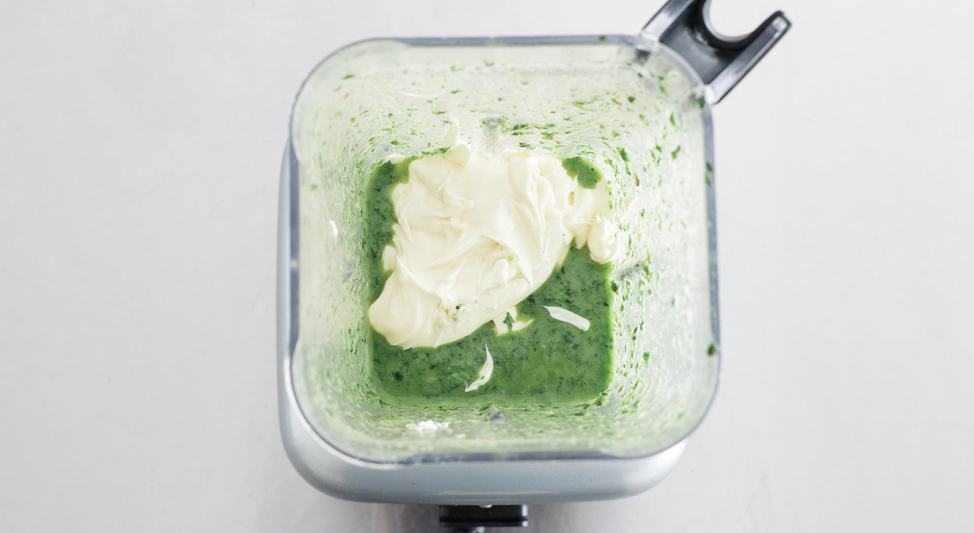 adding mayonnaise to a blender