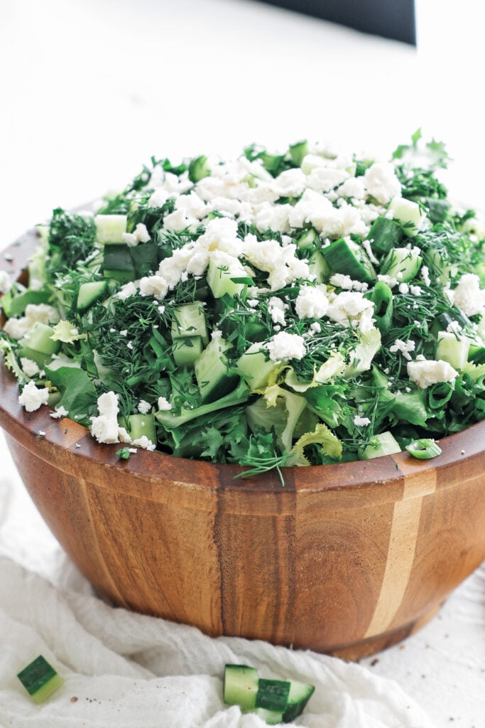 a large wooden bowl filled with maroulosalata