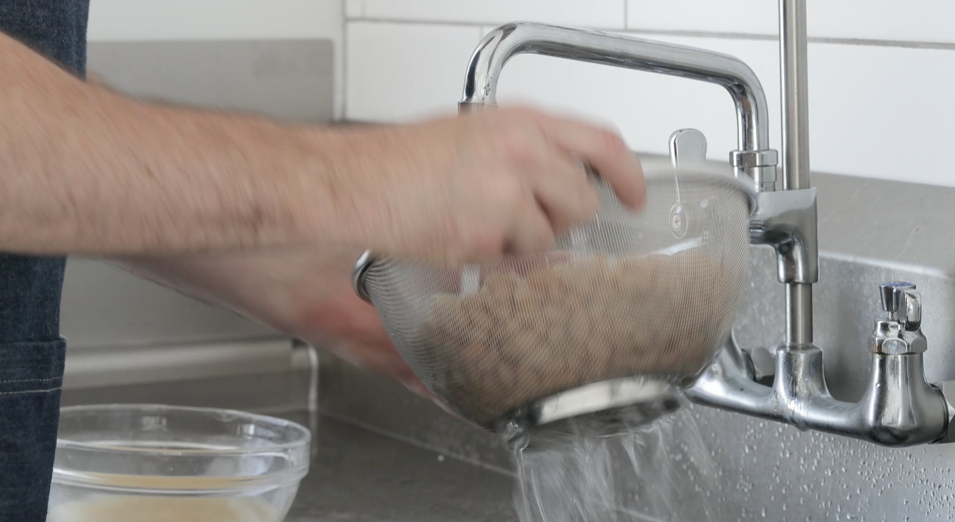 rinsing beans under water
