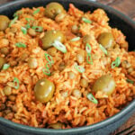 Arroz con gandules in a black serving bowl