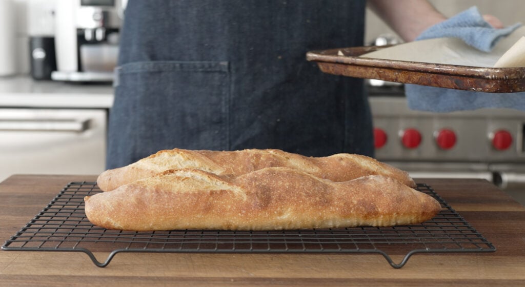 Steaming baguettes cooling on a rack