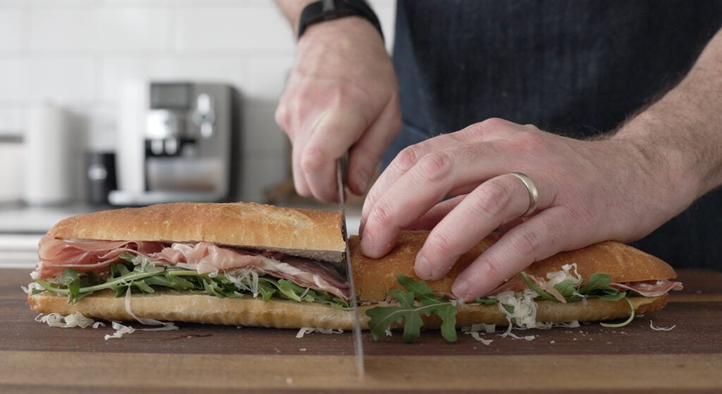 Completed sandwich being cut in half 