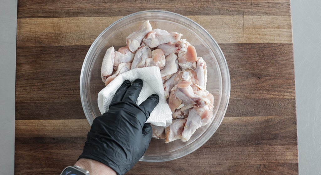 patting wings dry with a paper towel