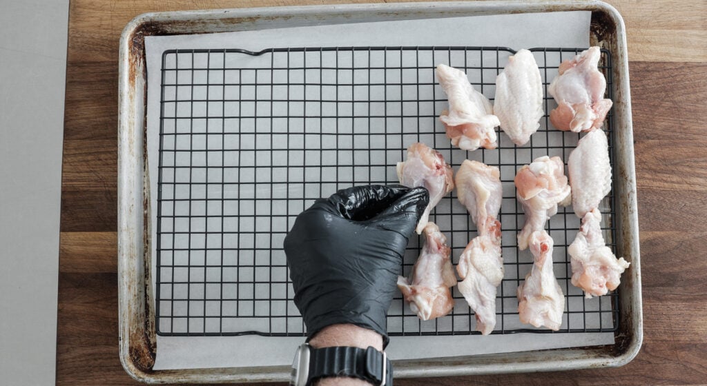 lining chicken wings on a wire rack