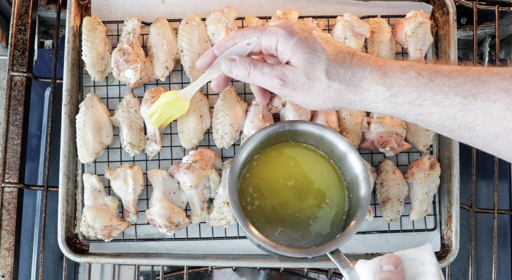 brushing wings with melted butter