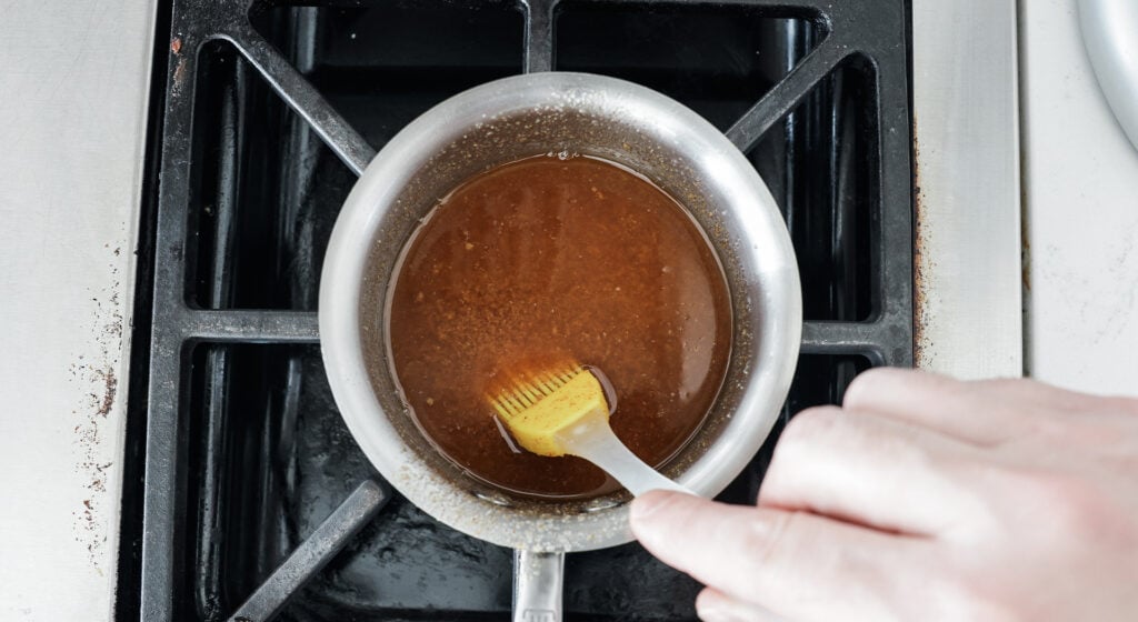stiring seasoned butter in a pan on the stove