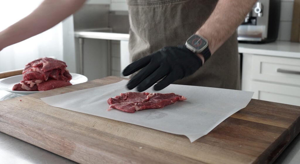 Slicing round steak into thin pieces