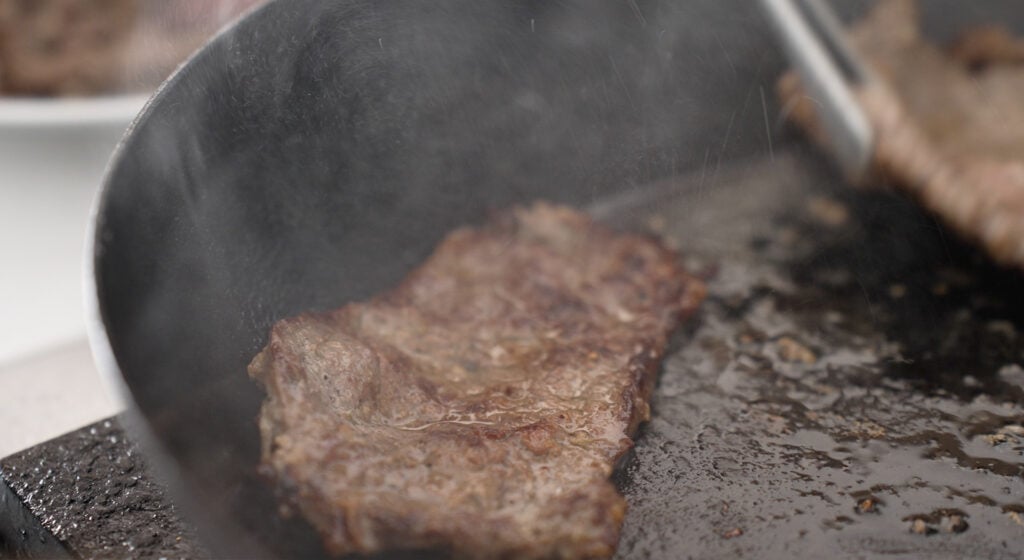 browned slice of meat in a pan