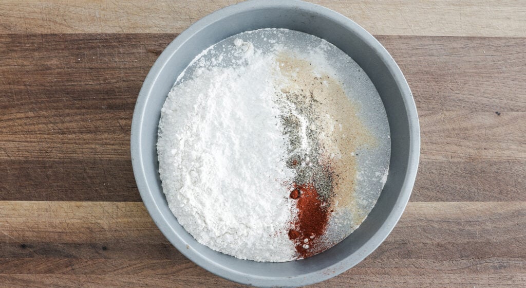 Shallow pan with flour and seasonings not yet mixed together