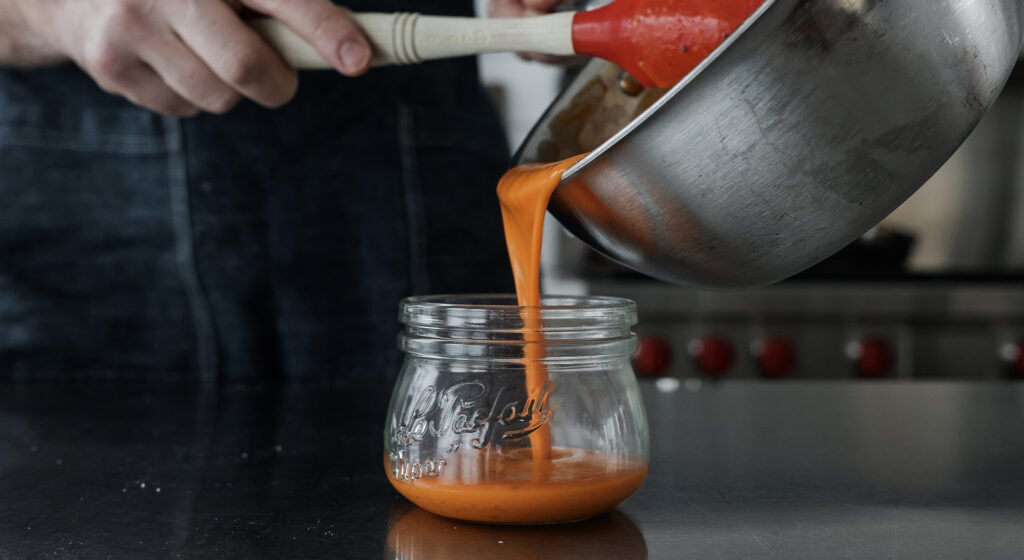 Pouring the sauce into a glass jar
