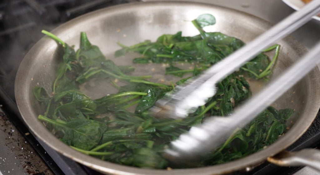 dark green wilted spinach in pan

