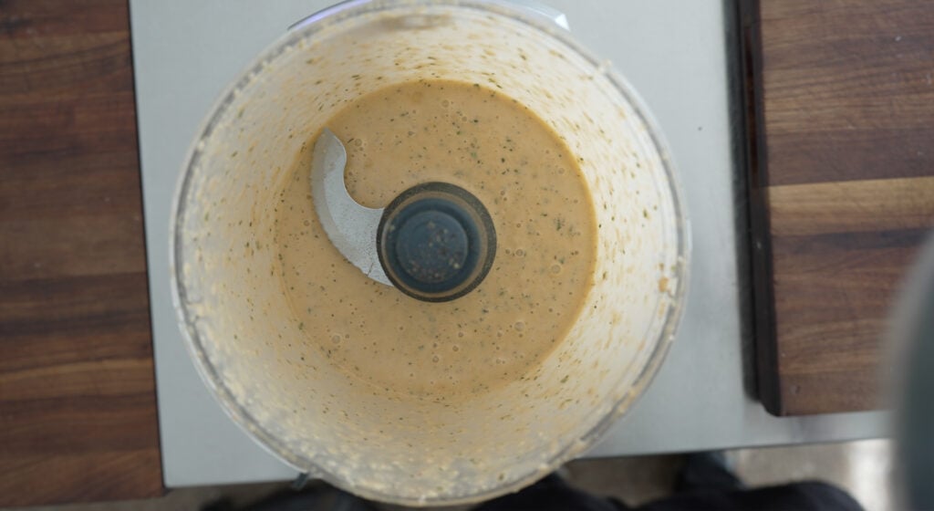 looking down into a food processor containing the blended marinade